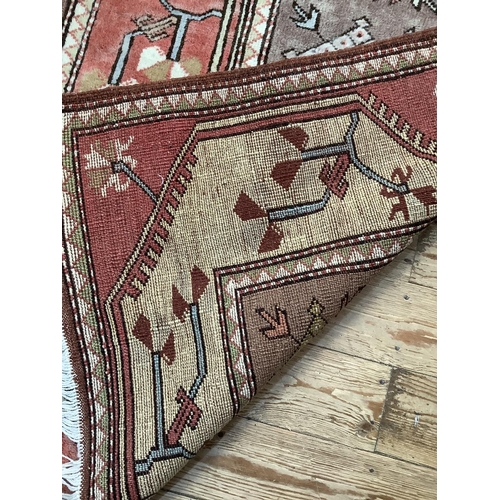 373 - A Turkish village rug hand knotted in classic colours of mushroom, ivory, salmon and brown, 140cm x ... 