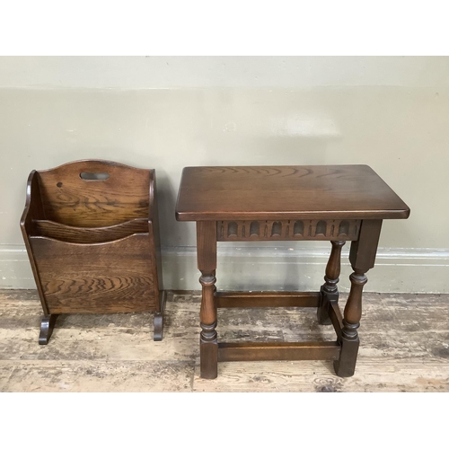 379 - An early 20th century oak magazine rack with finger grip on refectory supports, 32cm wide by 46cm hi... 