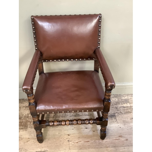 383 - A pair of oak open armchairs, brown hide upholstered with close nailing on turned and square framing