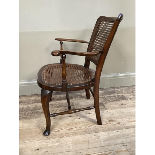 386 - A polished beech and bergere caned open armchair