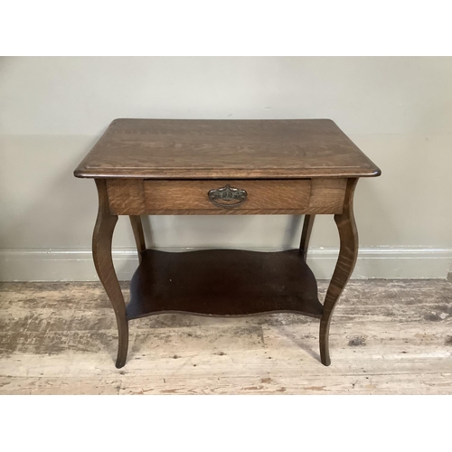 387 - A rectangular oak side table having a drawer to the frieze, on cabriole legs joined by an under tier... 