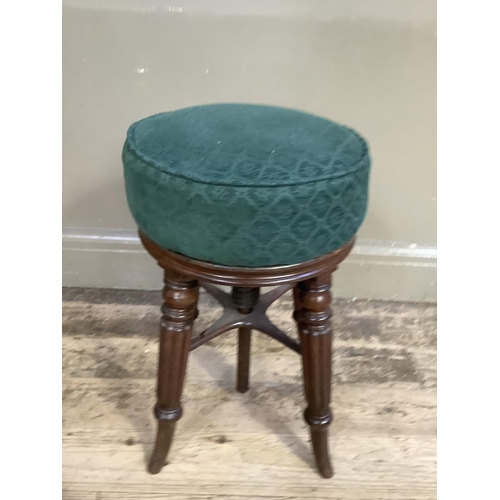 328 - A Victorian mahogany revolving piano stool on reeded and turned legs