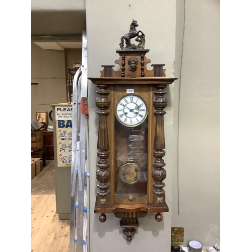 339 - A Victorian walnut wall clock having a white enamel two part dial with black Roman numerals, 8 day m... 