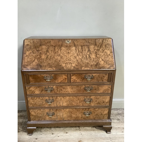 350 - A good reproduction figured walnut bureau having a fall front, the interior fitted above two short a... 