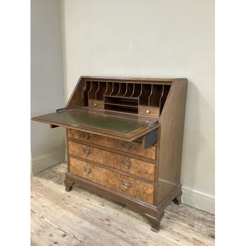 350 - A good reproduction figured walnut bureau having a fall front, the interior fitted above two short a... 