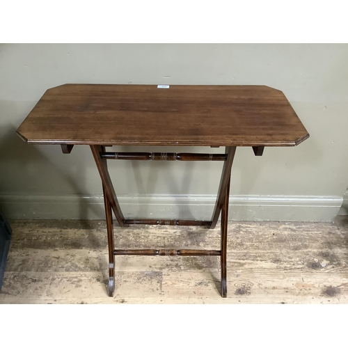 389 - An early 20th century mahogany folding table with boxwood stringing to the legs