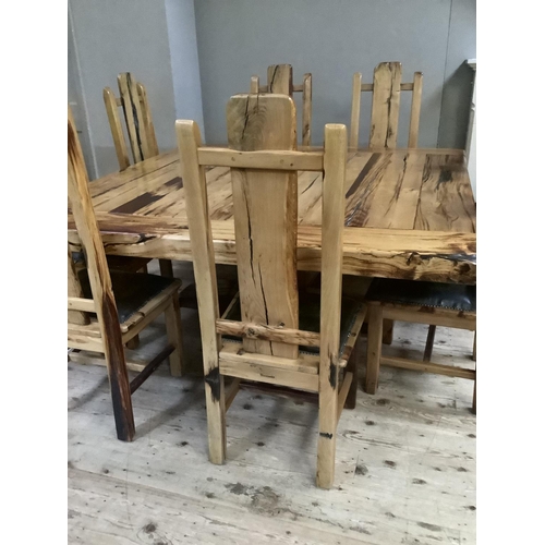 390 - A dining table and chairs by Jarobsky, made from South African railway sleepers comprising large squ... 