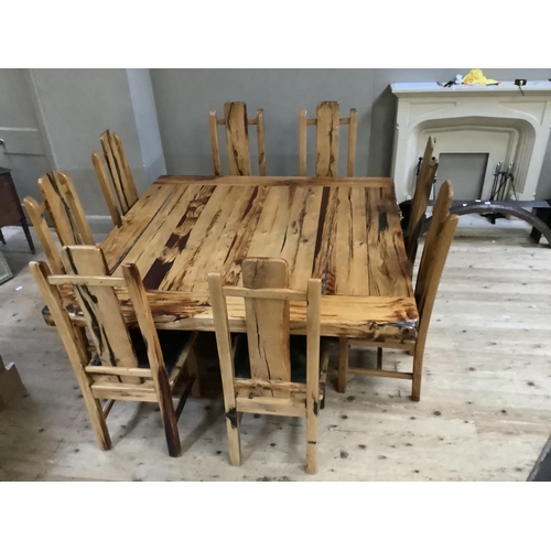 390 - A dining table and chairs by Jarobsky, made from South African railway sleepers comprising large squ... 