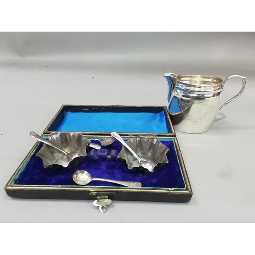 233 - An Edward VII silver cream jug engraved with a scroll cartouche, Sheffield 1906 and a pair of plated... 