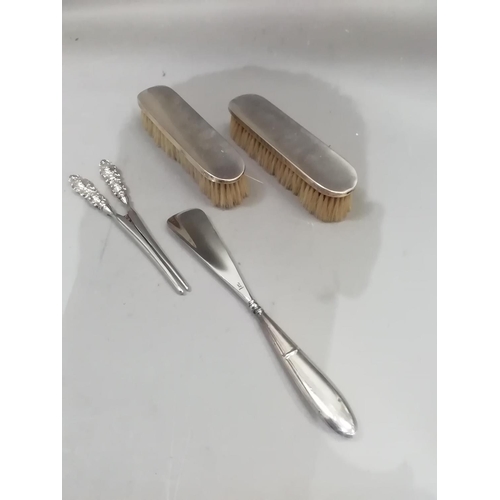 235 - A pair of silver hairbrushes, Sheffield 1904/15, a pair of plated glove stretchers and a shoe horn