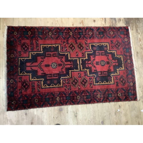 361b - A middle eastern rug of red ground