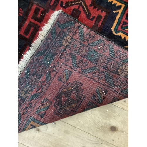 361b - A middle eastern rug of red ground