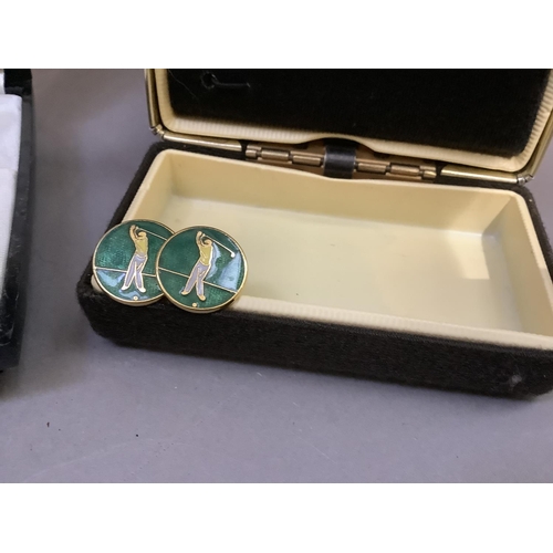 255 - A pair of gilt metal cufflinks enamelled in green, yellow and white with a golfer, together with a v... 