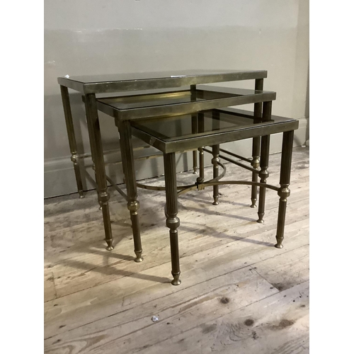 378 - A nest of three smoked glass and gilt metal coffee tables