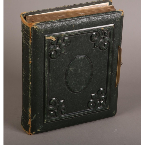 29 - A Victorian green leather bound photograph album containing solo and group portraits