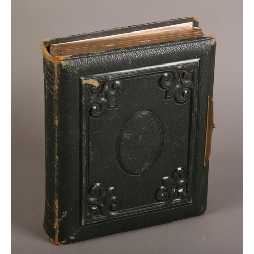 29 - A Victorian green leather bound photograph album containing solo and group portraits