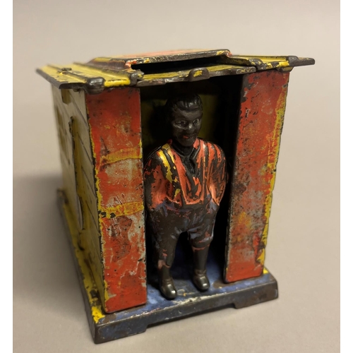 268 - A late 19th century American cast iron money box modelled as an African-American standing at the doo... 