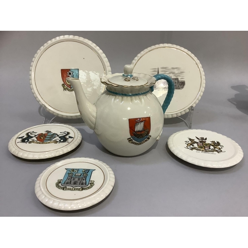 320 - W. H. Goss porcelain tea pot with Newport I. W crest 14.5cm high and two teapot stands with Southsea... 