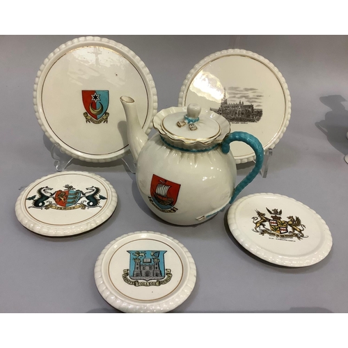 320 - W. H. Goss porcelain tea pot with Newport I. W crest 14.5cm high and two teapot stands with Southsea... 