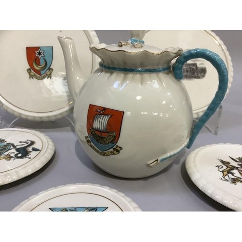 320 - W. H. Goss porcelain tea pot with Newport I. W crest 14.5cm high and two teapot stands with Southsea... 