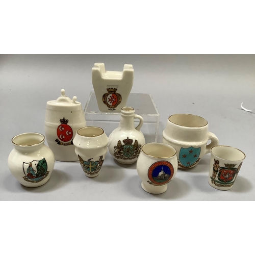 329 - A group of W. H. Goss porcelain overseas souvenirs including Maltese Fire Grate with matching crest,... 