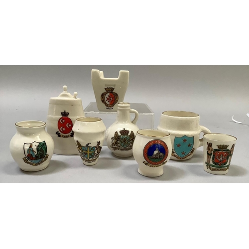 329 - A group of W. H. Goss porcelain overseas souvenirs including Maltese Fire Grate with matching crest,... 