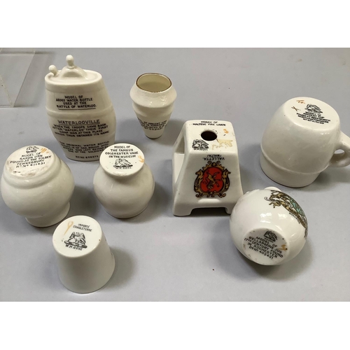 329 - A group of W. H. Goss porcelain overseas souvenirs including Maltese Fire Grate with matching crest,... 