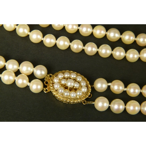 409 - CULTURED PEARL CHOKER NECKLACE in two strands of approximately 7mm pearls fastened with a 9ct gold t... 