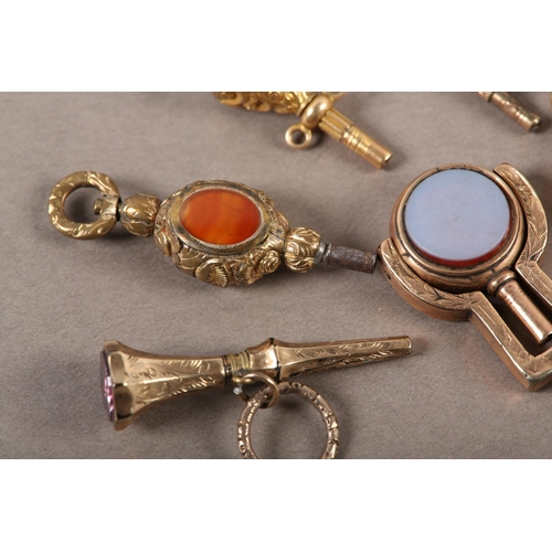 443 - A COLLECTION OF VICTORIAN POCKET WATCH KEYS  in rolled gold variously set with agate, cornelian, sar... 