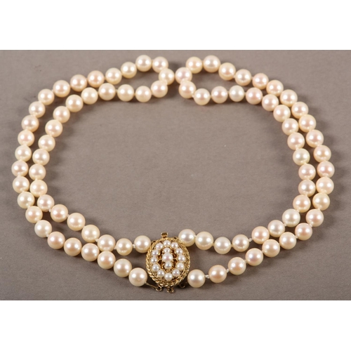 409 - CULTURED PEARL CHOKER NECKLACE in two strands of approximately 7mm pearls fastened with a 9ct gold t... 