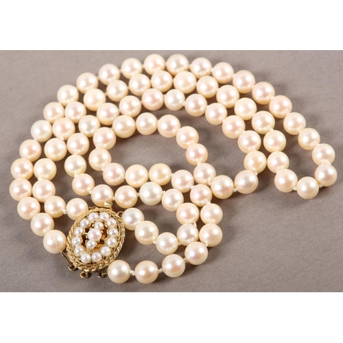 409 - CULTURED PEARL CHOKER NECKLACE in two strands of approximately 7mm pearls fastened with a 9ct gold t... 