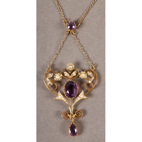 412 - A LATE VICTORIAN AMETHYST AND SEED PEARL HEART SHAPED PENDANT and chain in 9ct gold, the oval circul... 