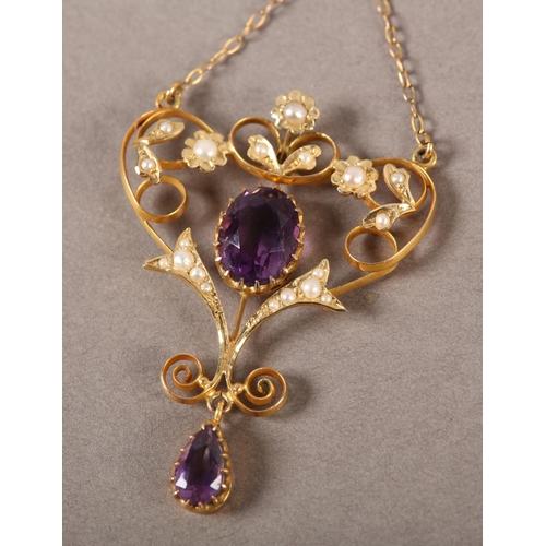 412 - A LATE VICTORIAN AMETHYST AND SEED PEARL HEART SHAPED PENDANT and chain in 9ct gold, the oval circul... 