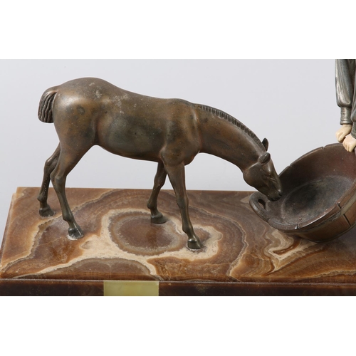 109 - AN ART DECO PAINTED METAL AND IVORINE FIGURE GROUP of a country girl feeding a donkey, on marble pli... 