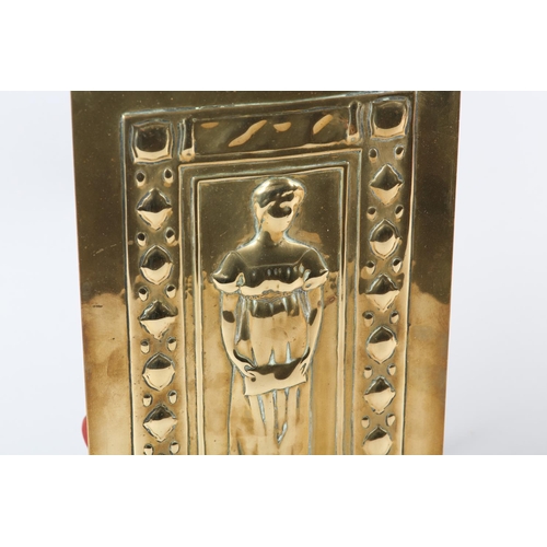 33 - AN ARTS AND CRAFTS BRASS PLAQUE, rectangular, embossed with full portrait of a female singer above t... 