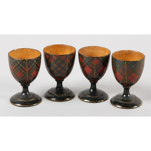 61 - A SET OF FOUR VICTORIAN TARTAN WARE EGG CUPS in McFarlane, McBeth, Stuart and McLean, 7cm high