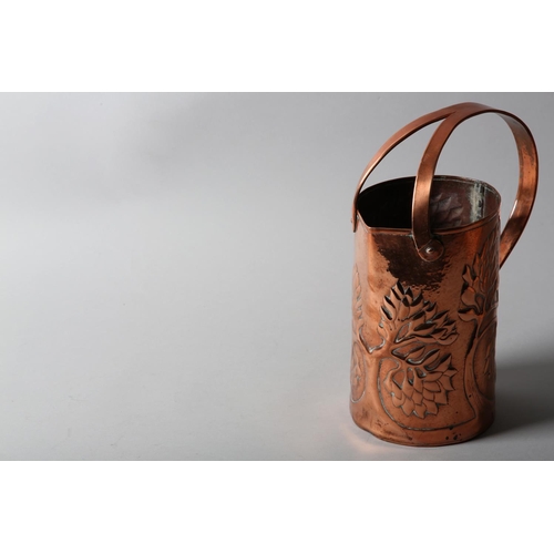 34 - AN ARTS AND CRAFTS COPPER INDOOR WATERING CAN, cylindrical, the rim nipped to create a pouring lip, ... 