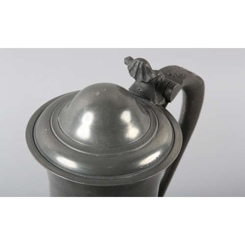 39 - A LARGE PEWTER LIDDED SERVING JUG FOR BEER, of baluster form, the lid with acanthus thumb piece, 'S'... 