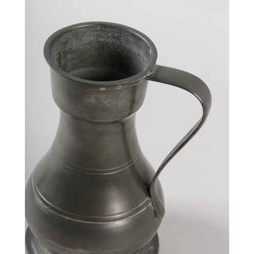 41 - A PEWTER SERVING JUG of baluster form, strap handle, marked to the rim with maker, date and assay of... 