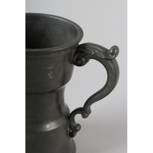 43 - AN UNUSUAL PEWTER TANKARD waisted form, leaf capped scroll handle, marked to the rim with LONDON, X ... 