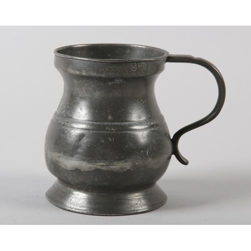 44 - A VICTORIAN HALF PINT PEWTER TANKARD, stamped  and maker's stamp '9' to the rim, 9cm high