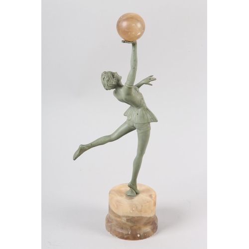 110 - AN ART DECO VERDIGRIS - FINISHED METAL FIGURE OF A DANCER, her arm raised and holding an alabaster b... 