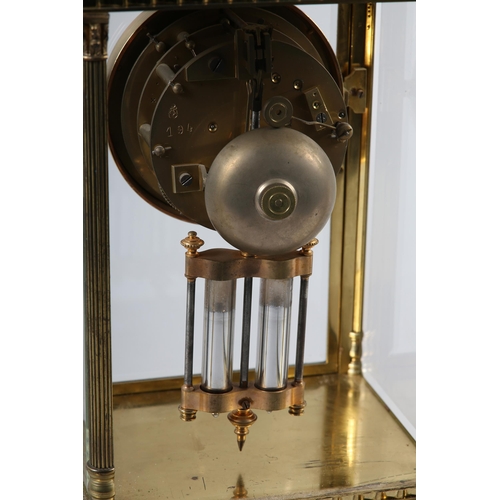 86 - A LATE 19TH CENTURY FRENCH FOUR LIGHT STRIKE CLOCK in a brass columned case, the four bevelled glass... 