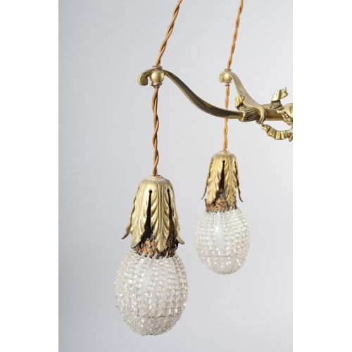 2 - A PAIR OF EARLY 20TH CENTURY FRENCH GILDED BRASS PENDANT LIGHT FITTINGS, each cast as two crossed bo... 