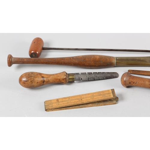 67 - A COLLECTION OF 19TH CENTURY HARDWOOD AND BRASS MOUNTED LEATHER WORKING TOOLS, two with agate heads,... 