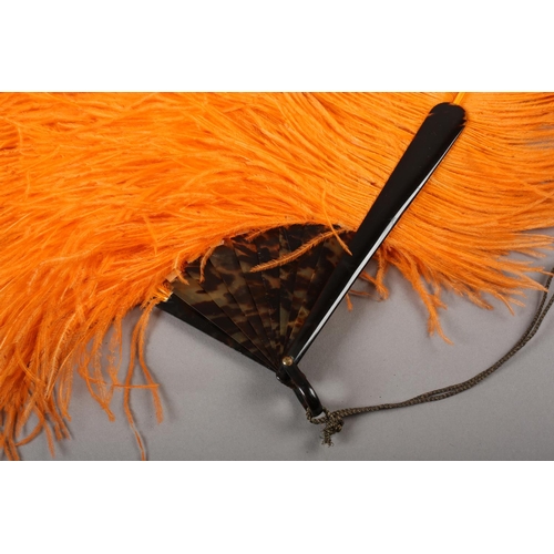 108 - 1920’s vibrant orange ostrich feather fan, large and showy, the monture of tortoiseshell, frothy fea... 