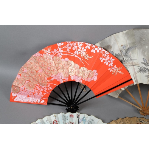 129 - Japan: Four Japanese fans to include a large folding fan with knotted cord decoration to both guards... 