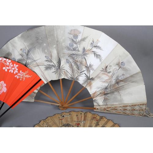 129 - Japan: Four Japanese fans to include a large folding fan with knotted cord decoration to both guards... 