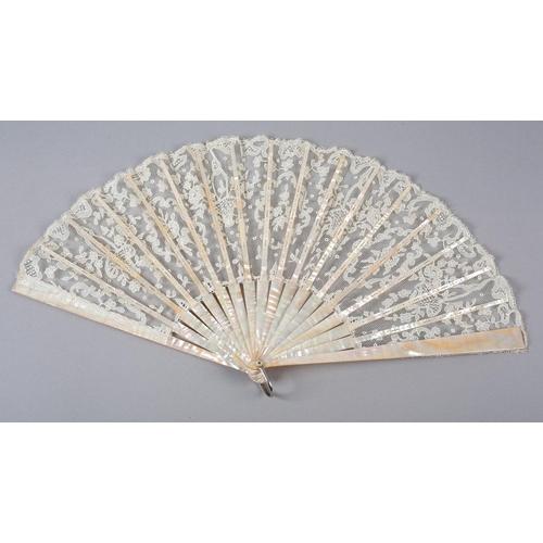 149 - A folding fan c 1900 with pink mother of pearl monture, continuing onto the ribs, the lace leaf of a... 