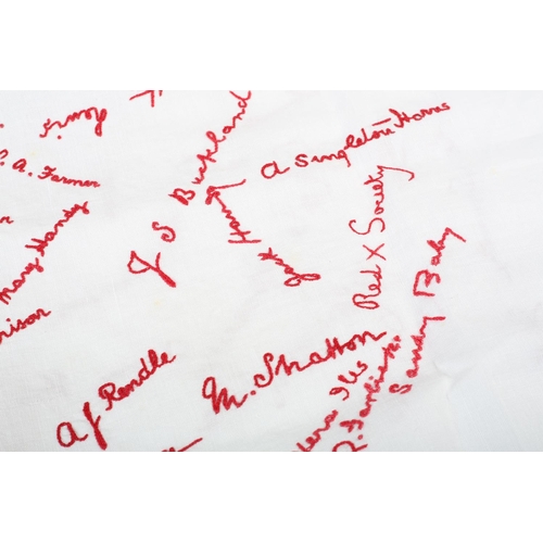 172 - An autographed friendship tablecloth, linen embroidered in red with multiple names of the participan... 